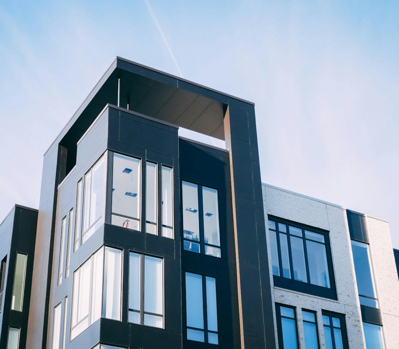 black and white cocnrete building low-angle photography